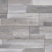 A close-up of MSIs XL Cyrus Woburn Abbey Luxury Vinyl Planks BOX (22.44 SQFT), featuring waterproof, rectangular plank-style tiles in gray tones with realistic wood grain and natural patterns for an authentic look.